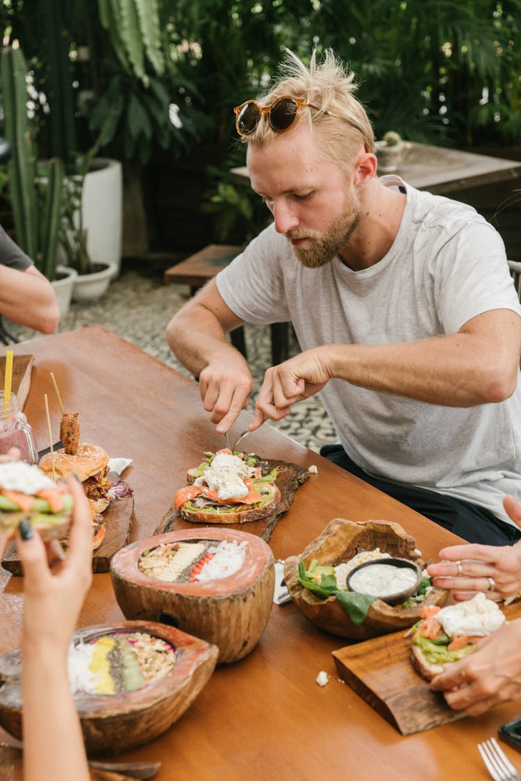 Man Eating With His Friends