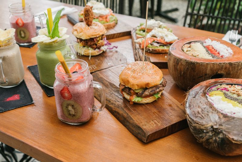 Gourmet burgers served with smoothies — photo by ArtHouse Studio on Pexels