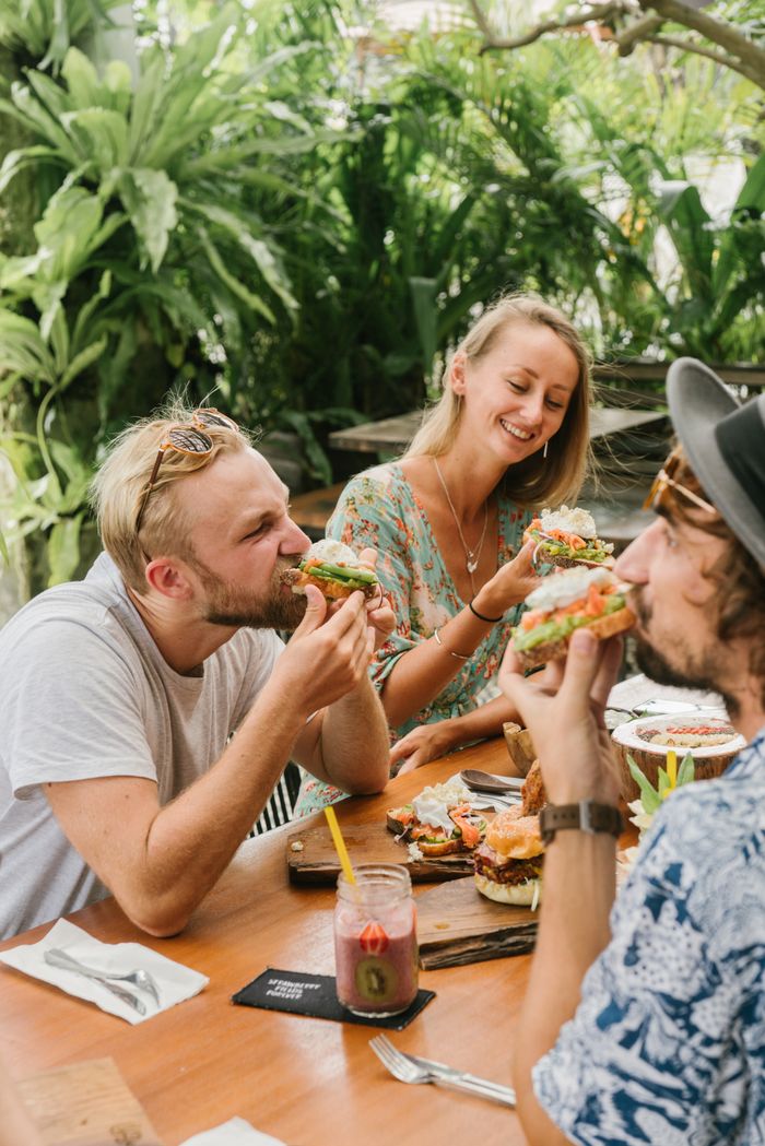 Friends eating lunch together on a patio