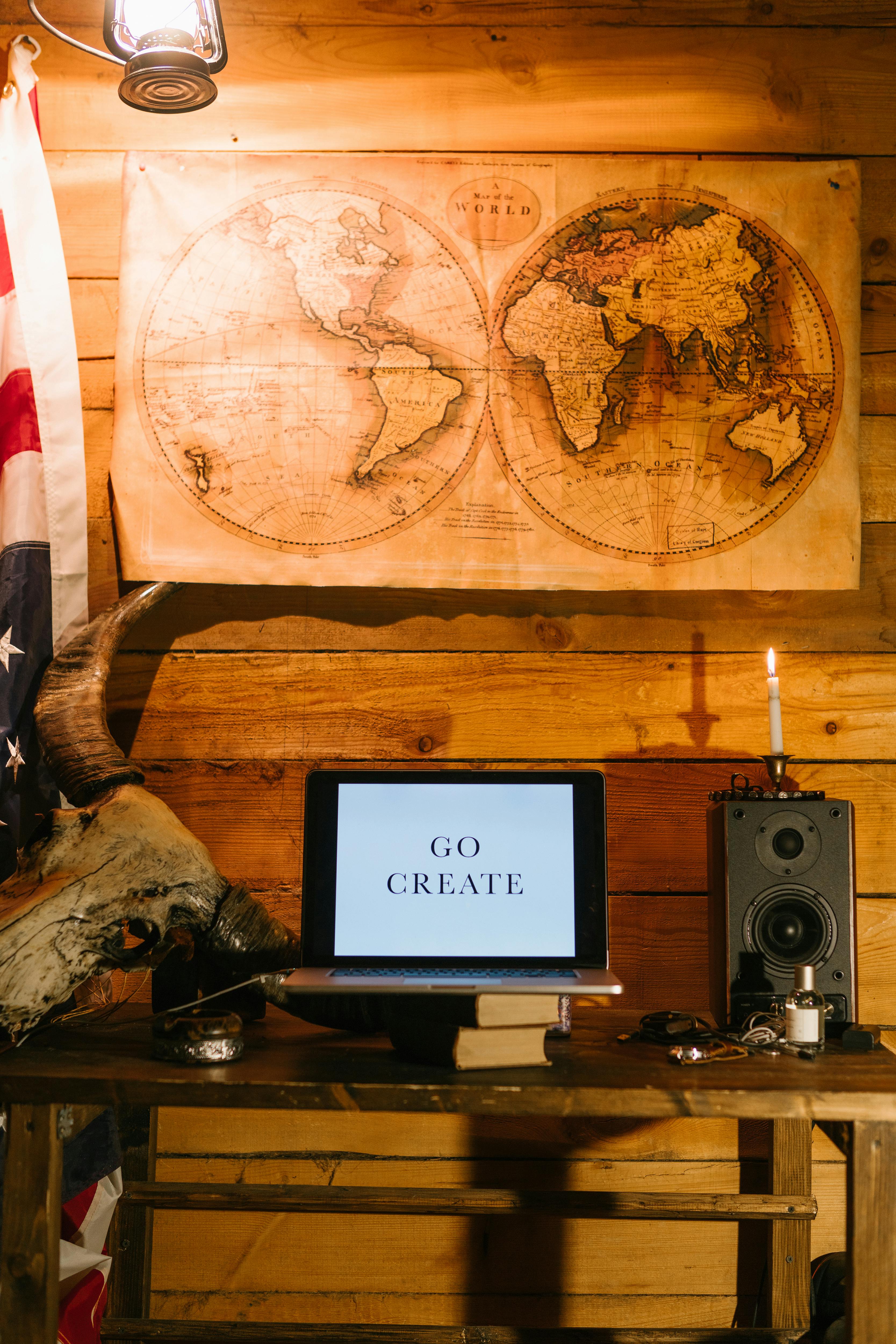 A cozy vintage workspace featuring a world map, laptop, and retro decor, evoking a creative ambiance.