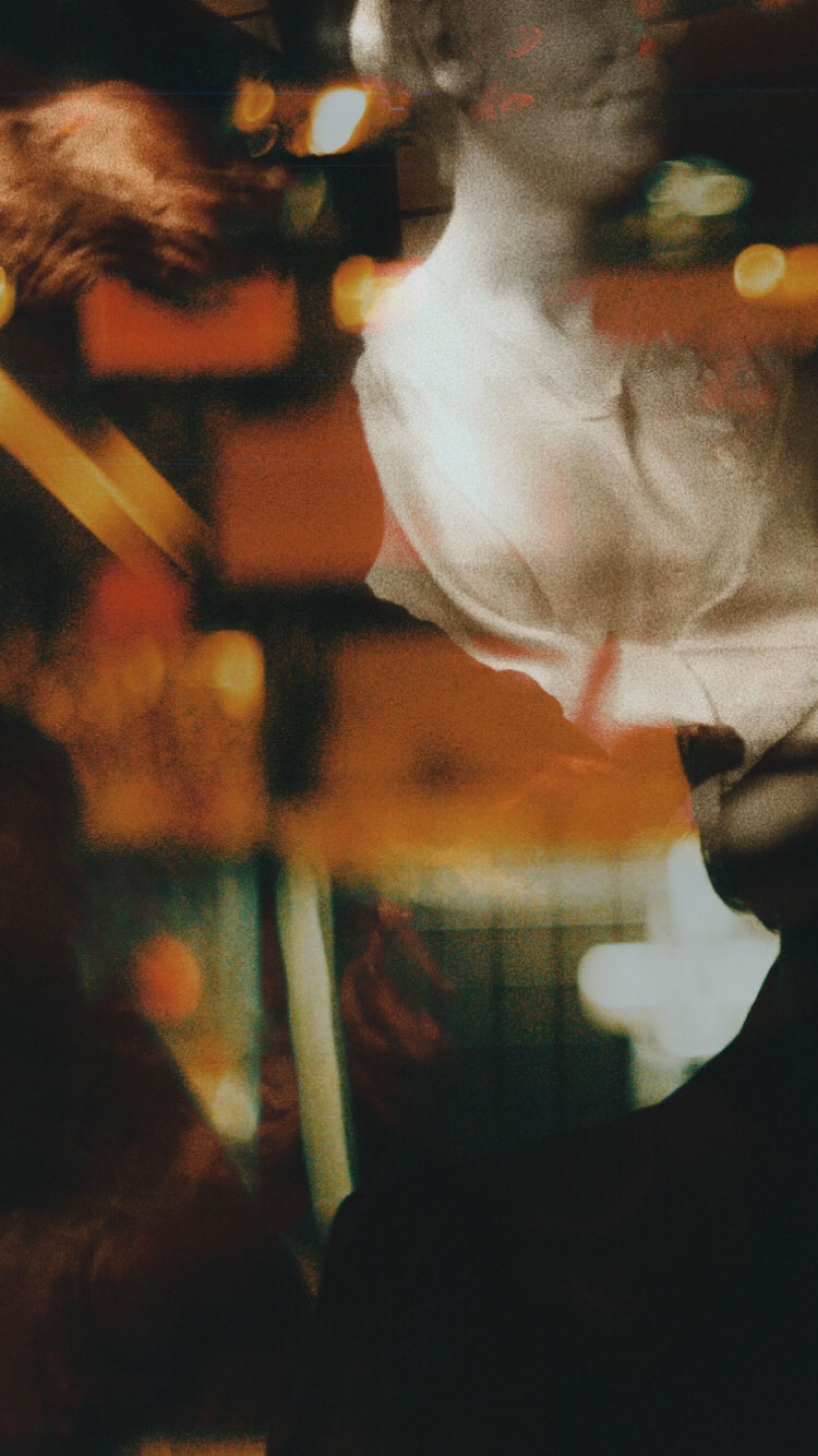 Historic sculptural image of head of person among bright blurred illuminated lights in room