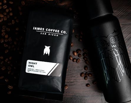 Top view of coffee beans with packaged coffee and refillable hot drink bottle