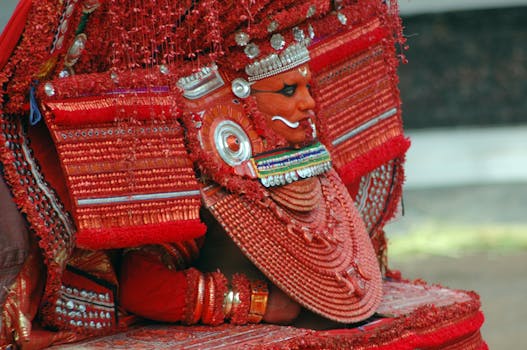 Colorful traditional Theyyam performer in Kerala, showcasing vibrant cultural heritage.