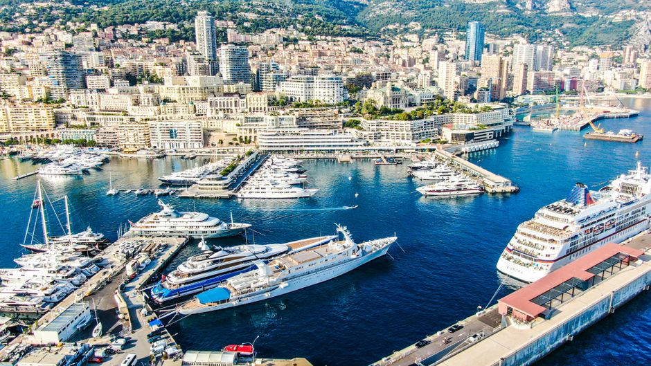 Ultimate The Very Best of French Riviera in One Day – Cannes, Antibes, Nice, Eze, Monaco Review 2026 - Aerial view of Monaco's bustling harbor with yachts and cityscape in the background.