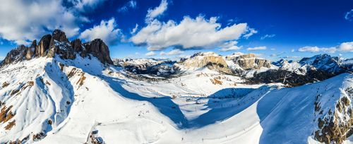 Free Breathtaking aerial view of snow-covered mountain ranges under a clear blue sky in winter. Stock Photo
