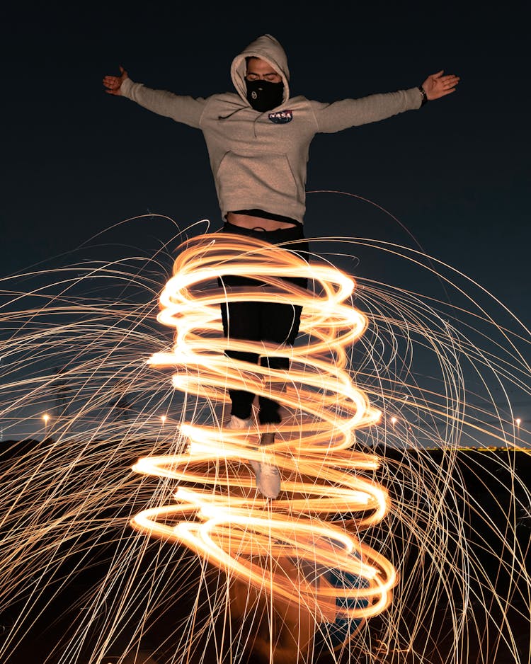 Unrecognizable Man Standing In Vortex Of Shiny Freeze Light