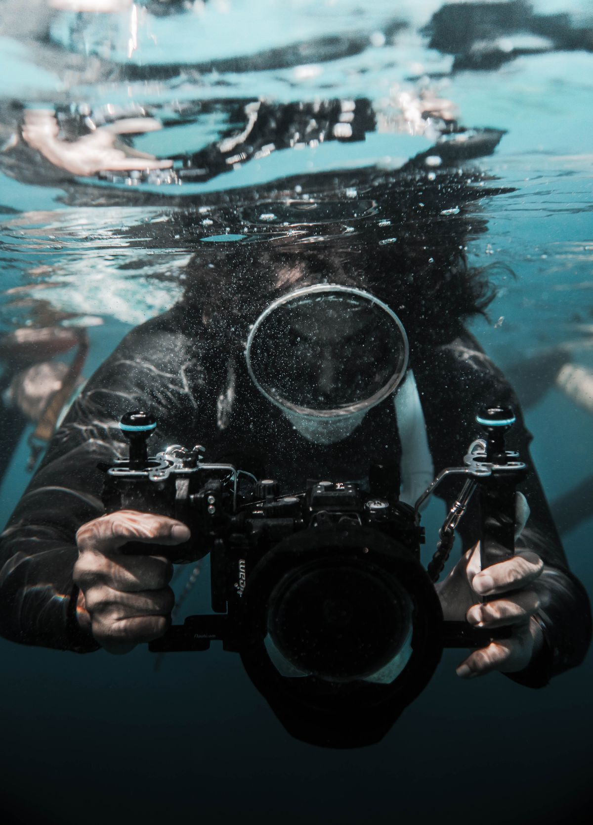 Diver holding a professional underwater camera
