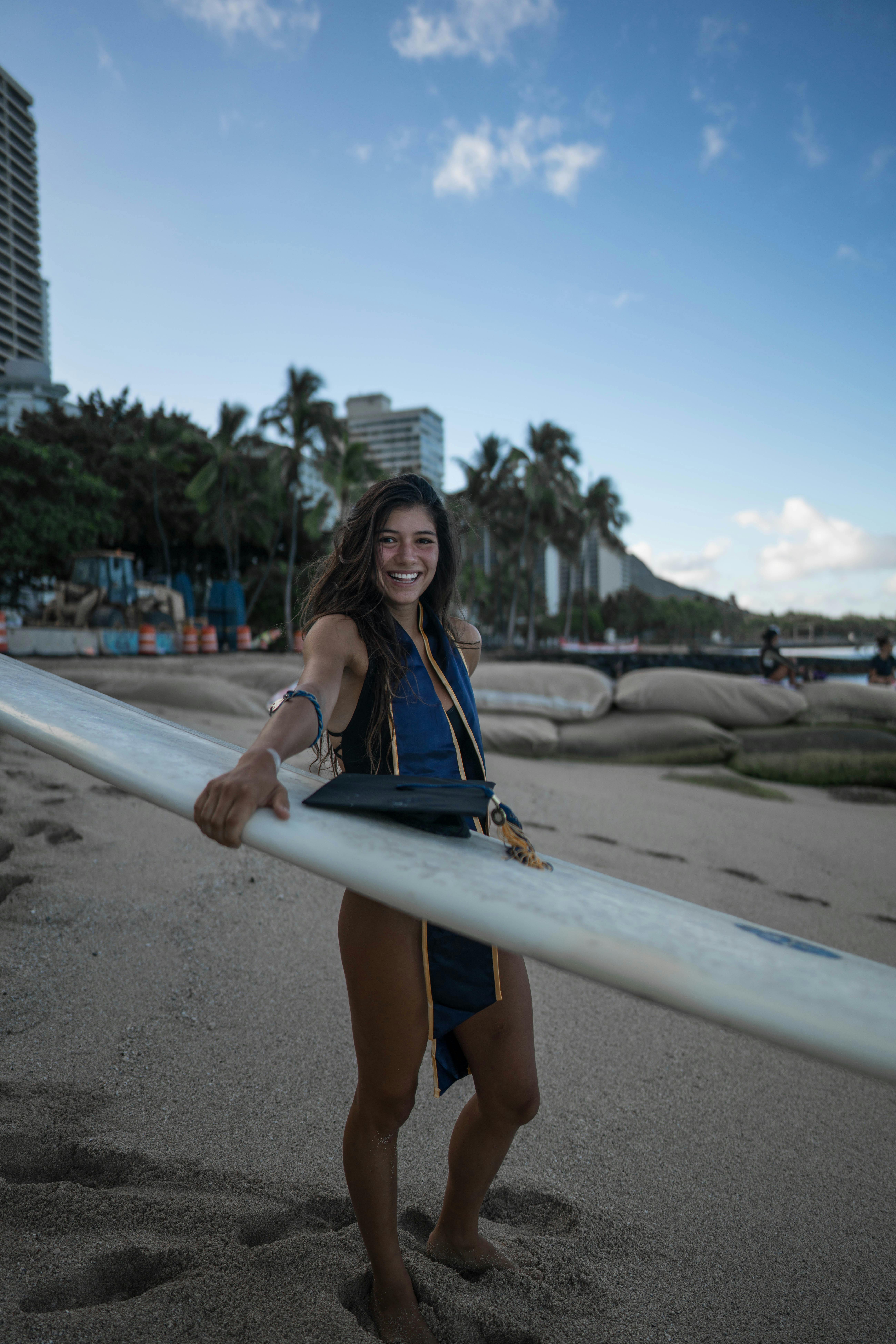 Woman Carrying a Surfboard · Free Stock Photo