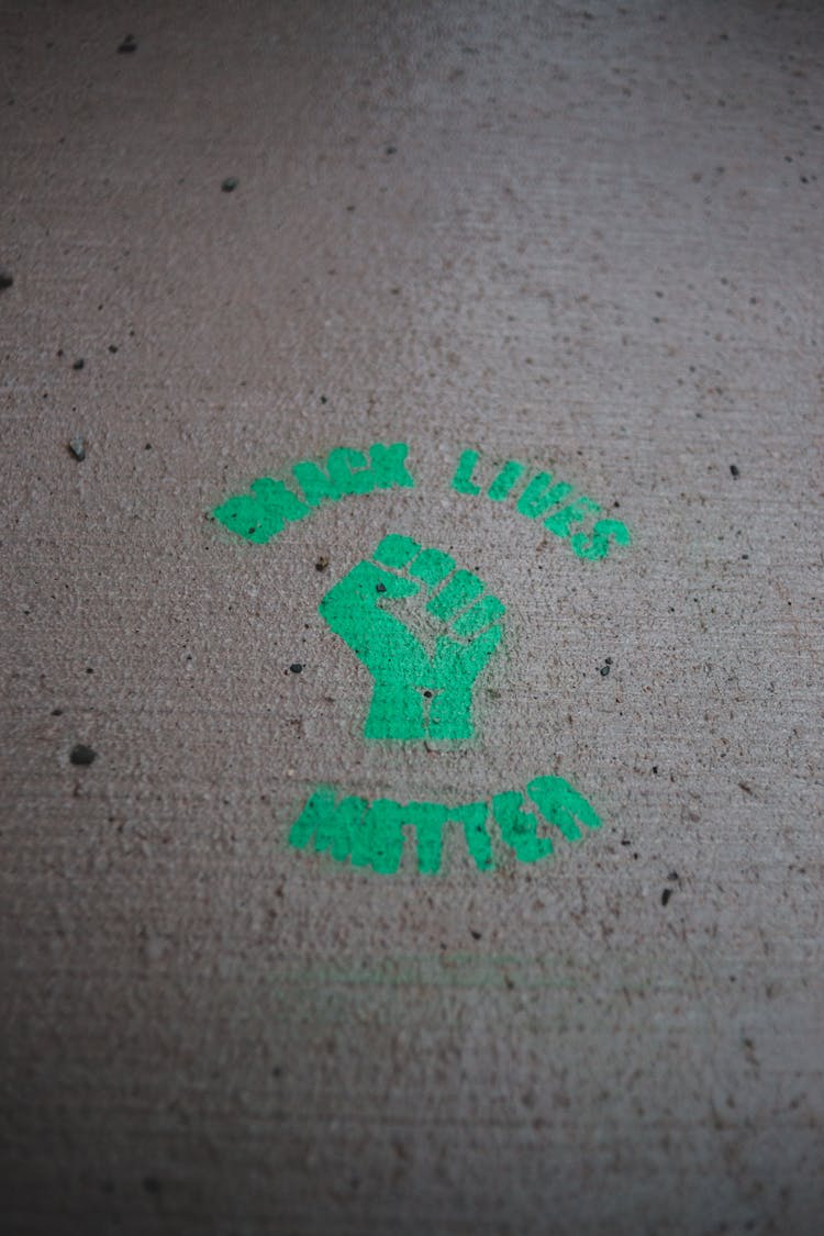 Green Logo Of Black Lives Matter Movement On Road