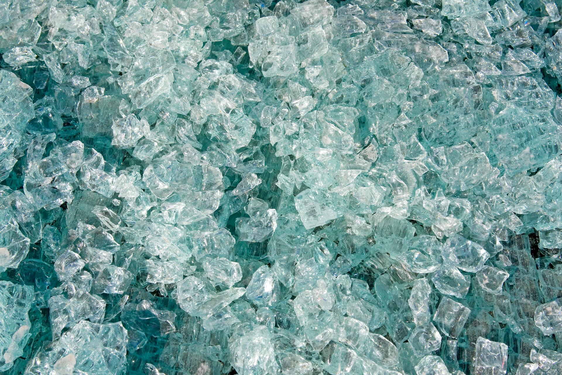 Close-up view of shattered clear glass pieces with a reflective texture.