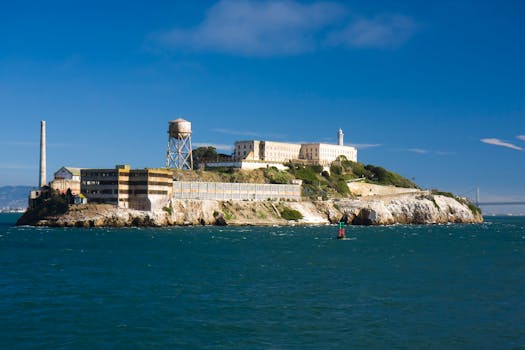 Sunny view of Alcatraz Island, historic prison in San Francisco Bay, California.