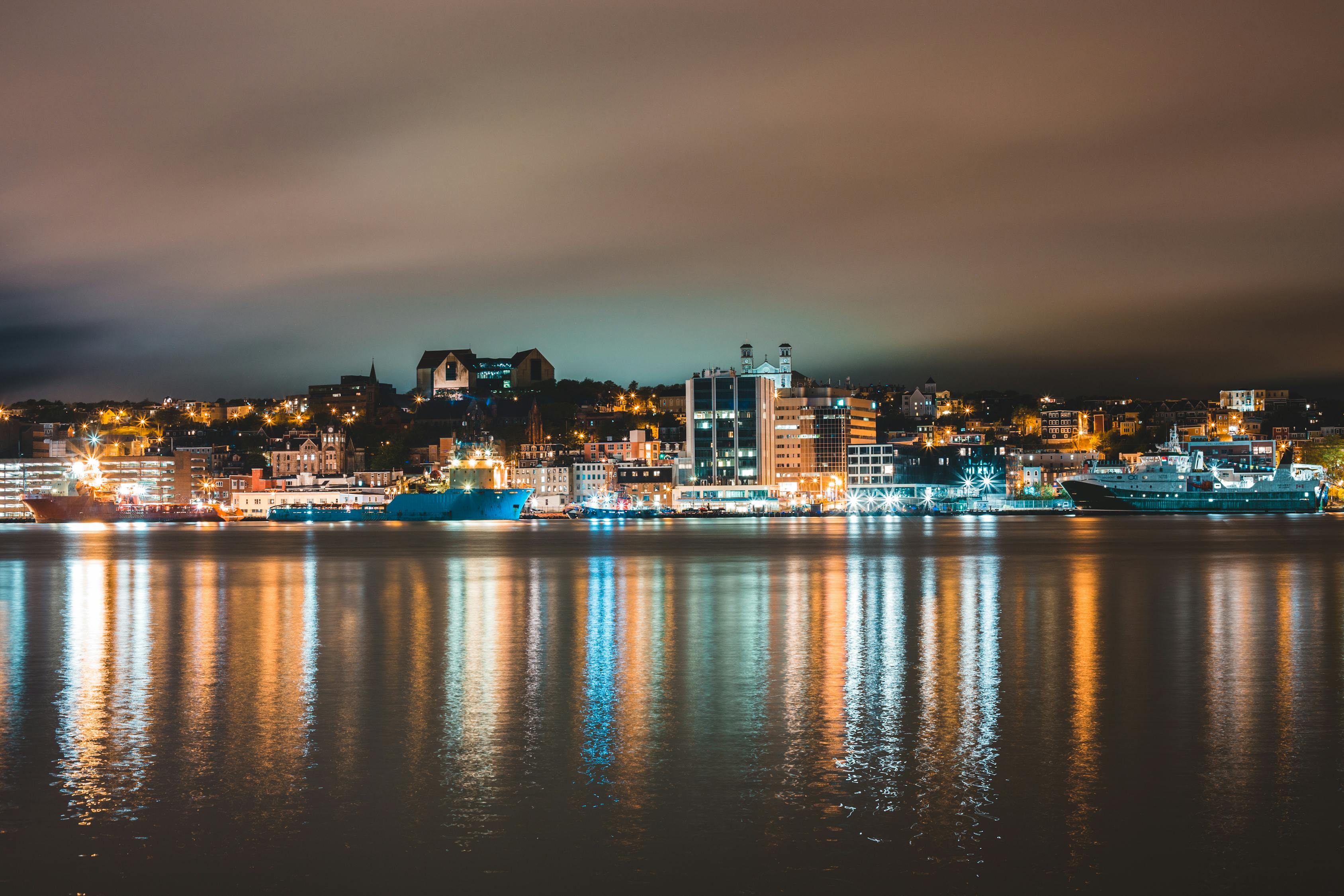 Cityscape with illuminated harbor and buildings in evening · Free Stock ...