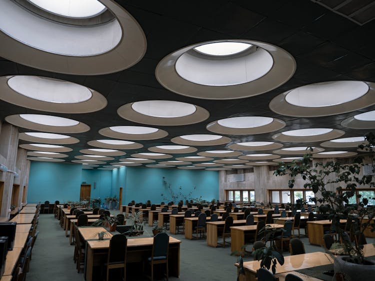 Empty Class With Round Windows On Ceiling And Various Potted Plants