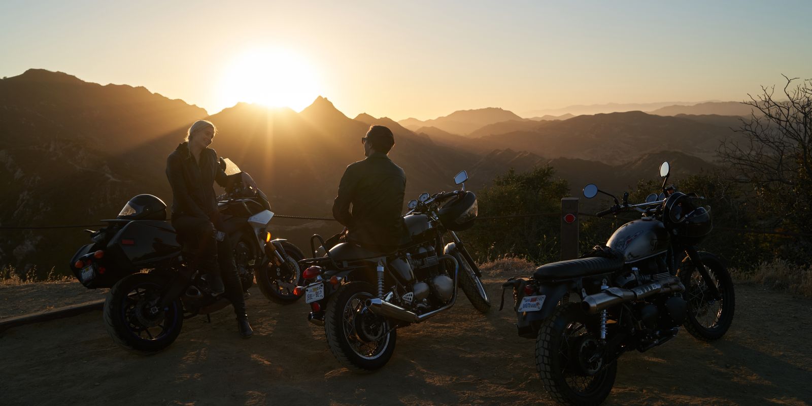Motorcyclists enjoying a sunset view in the mountains