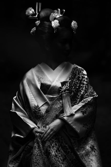 Artistic black and white portrait of a woman in traditional attire.