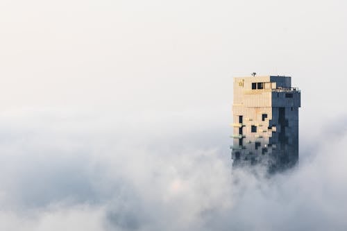 A Building Surrounded by White Clouds