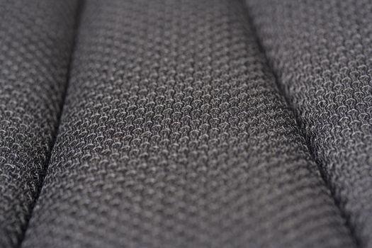 Close-up image of textured gray fabric showcasing intricate pattern and weave details.