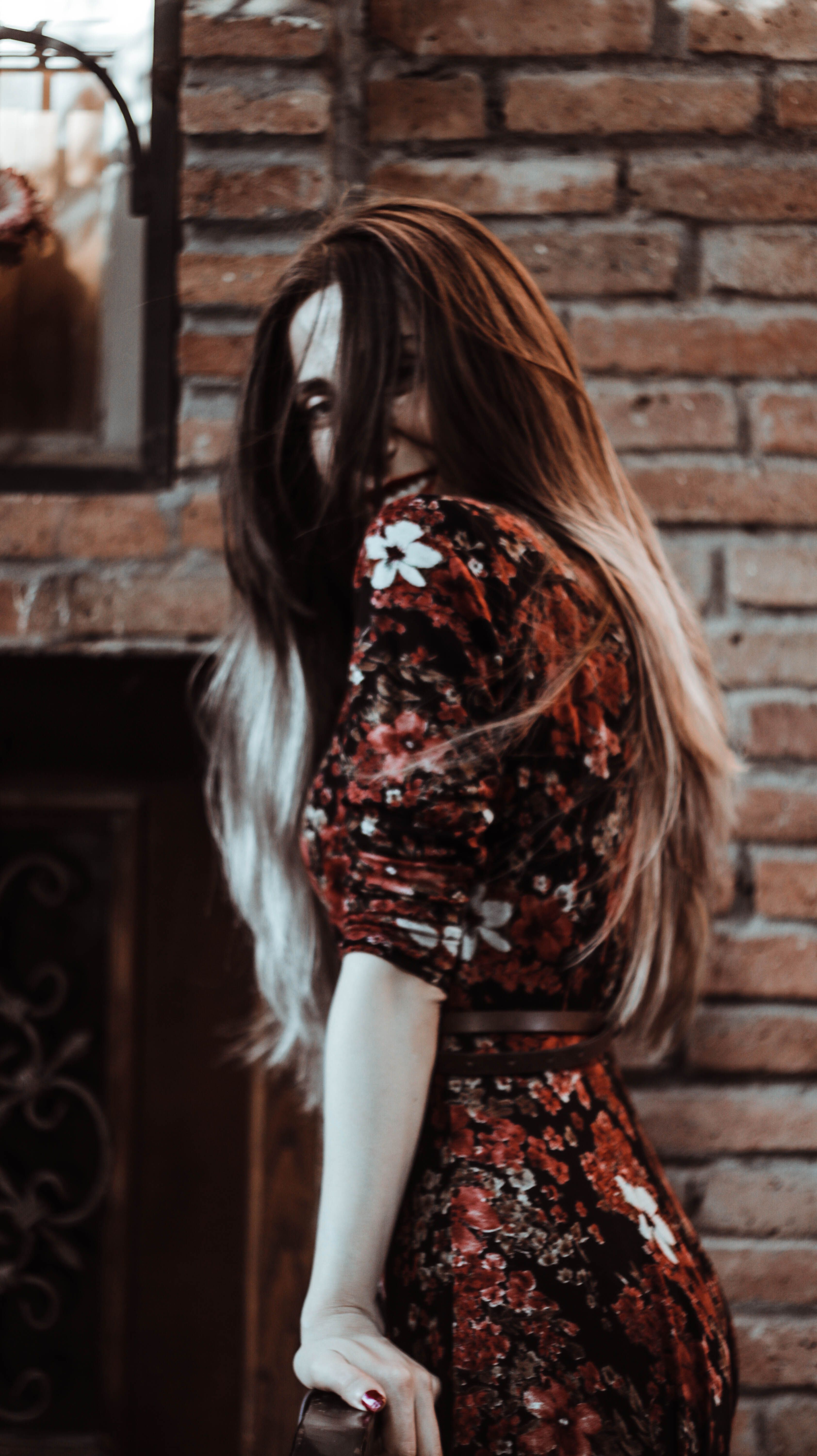 Stylish young woman covering face with hair · Free Stock Photo