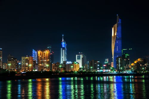 Free High Rise Buildings Near Body of Water during Night Time Stock Photo