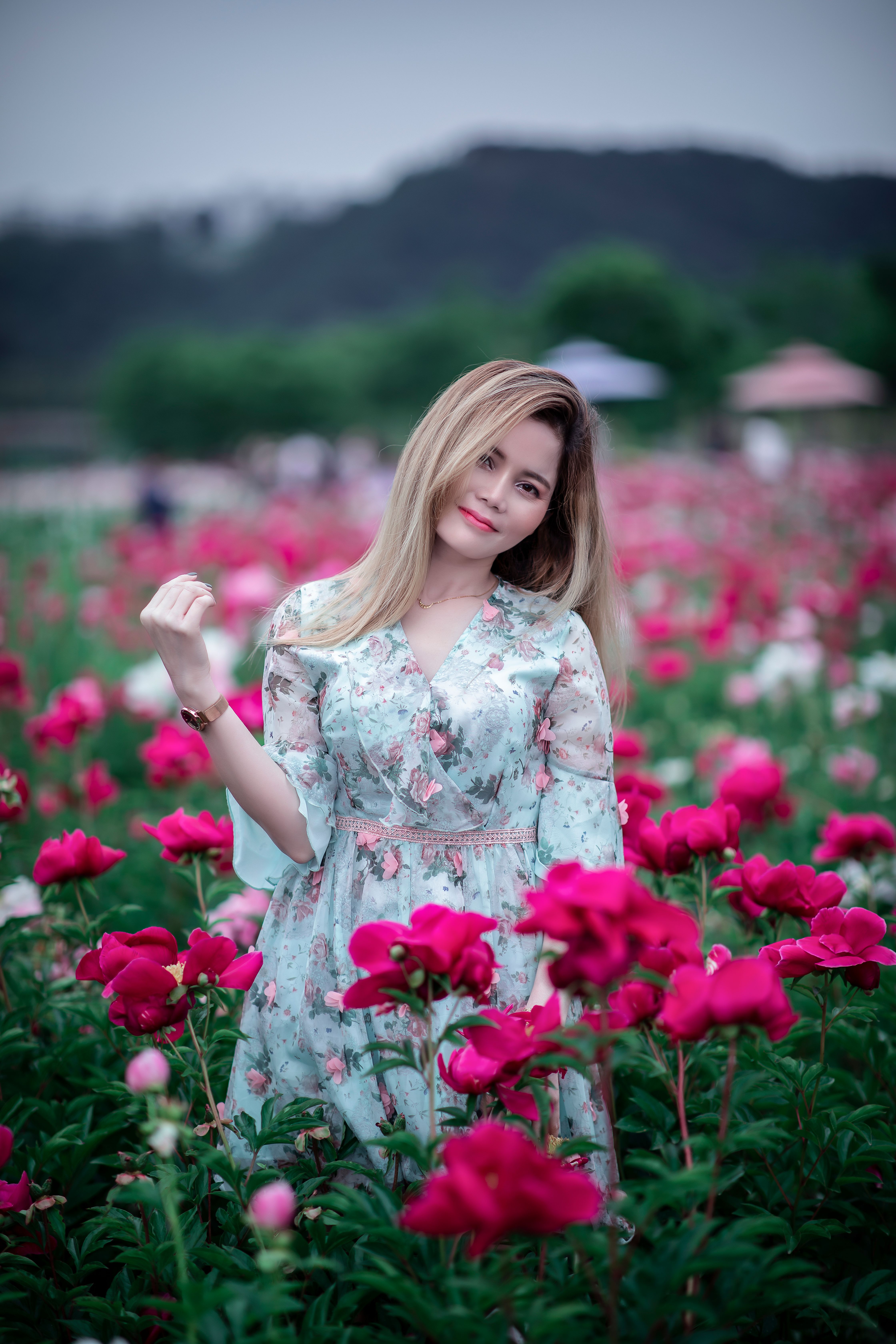 A Woman in White Floral Dress Standing on Flower Field · Free Stock Photo