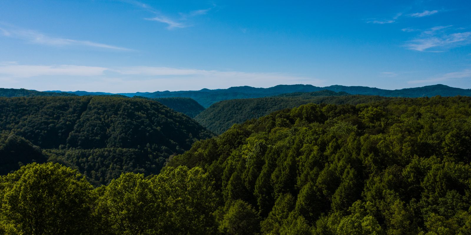 Green mountain ridges beneath a blue sky in Appalachia