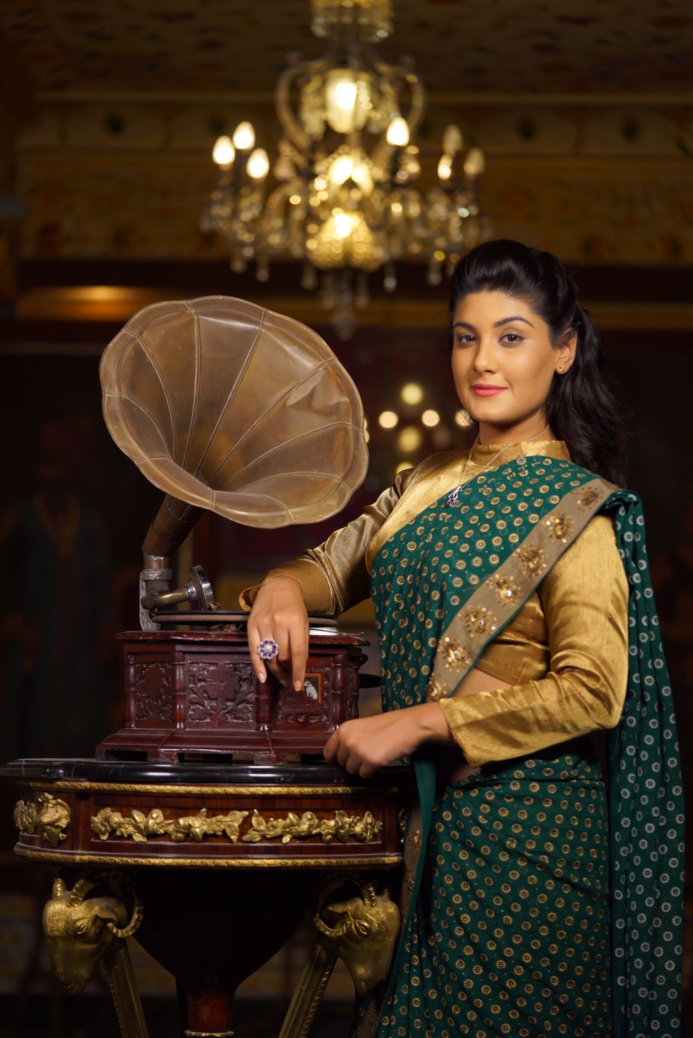 Woman in traditional dress beside a vintage gramophone