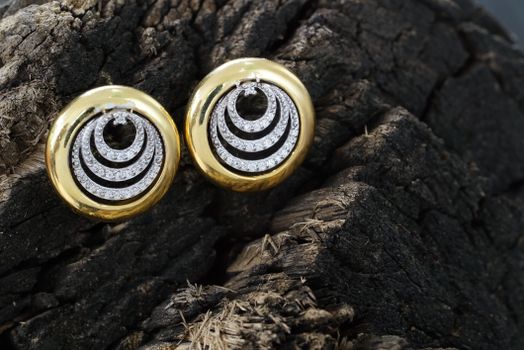 Golden accessories with shiny brilliants on wood