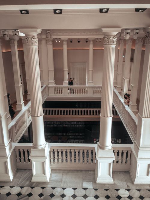 Free Indoor view of a museum with classical columns and symmetrical architecture. Stock Photo