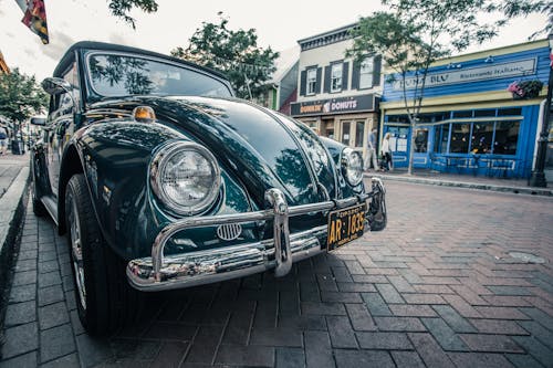 Green Volkswagen Beetle Parked on Sidwalk