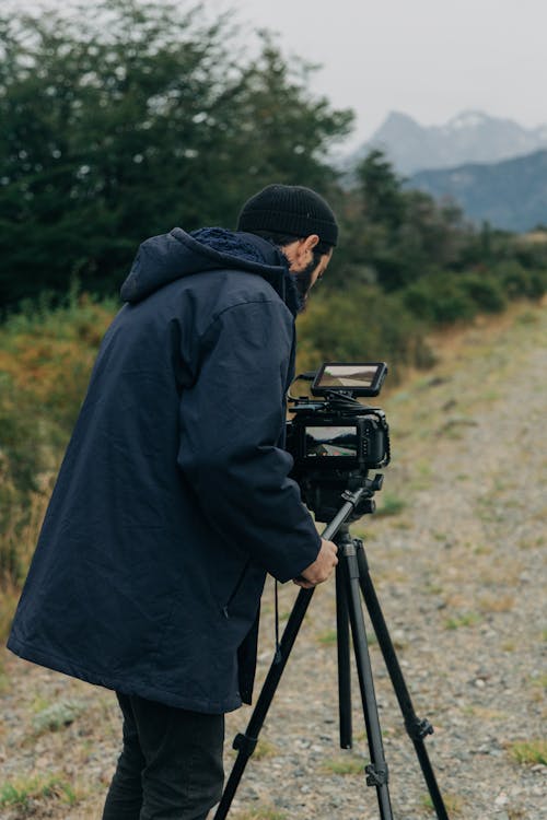 Man Adjusting a Camera