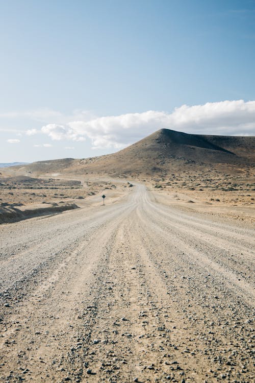 Long Dirt Road Under Blue Sky