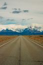 Gray Asphalt Road Near Snow Covered Mountains