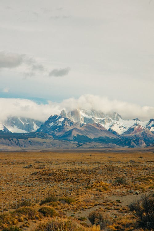 Landscape with Steppe and Rocky Mountains in Snow