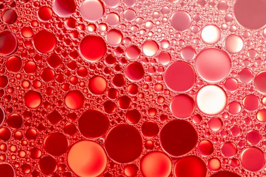 A stunning abstract composition of vibrant red oil and water bubbles creating a unique pattern.