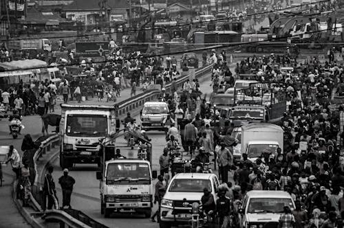 Free Crowd and cars on road in city Stock Photo