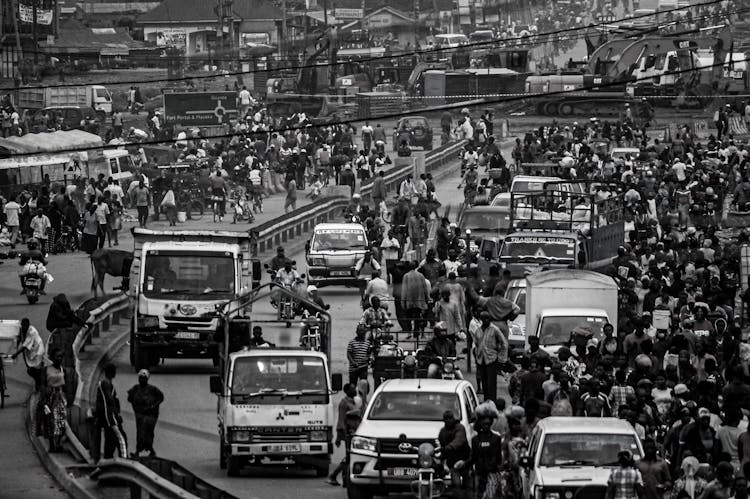 Crowd And Cars On Road In City