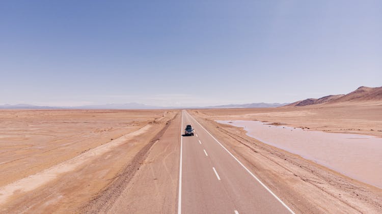 Car On Road Through Plains