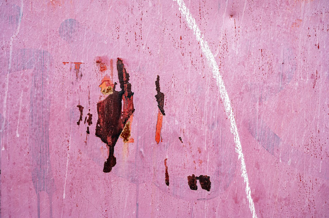 white and red lines and spots on surface of old shabby dirty pink wall
