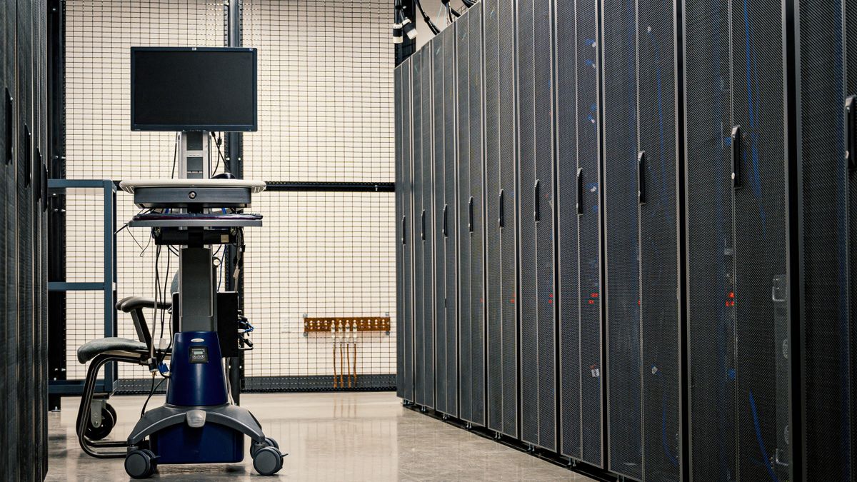Rows of server racks and cabling inside a data center, a real stock photo chosen because Xbox Cloud Gaming streams games from data centers like this one, with no people in the frame
