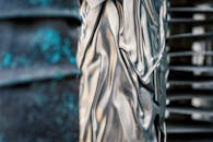 Abstract background of crumpled shiny metallic fabric