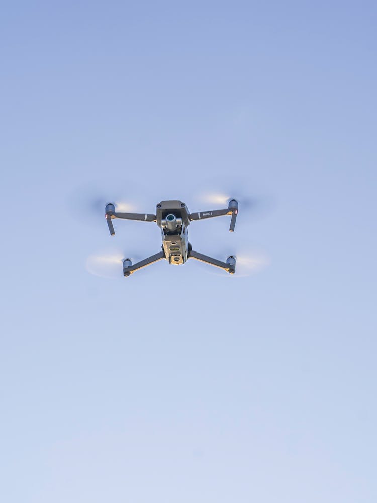 Drone Flying In Blue Sky While Recording Video