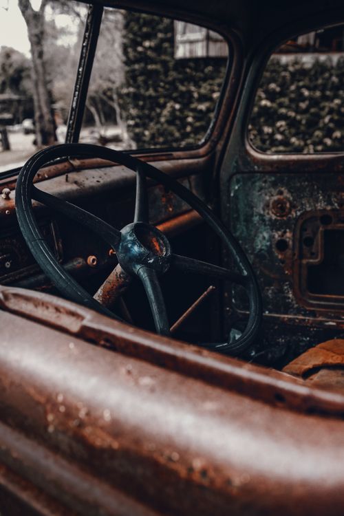 Free Close-up of a rusty vintage car interior in Bonito, Brazil, showcasing a weathered steering wheel. Stock Photo