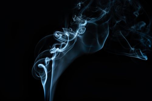 Free Abstract backdrop of wavy smokey creating shiny swirls in air on black background Stock Photo