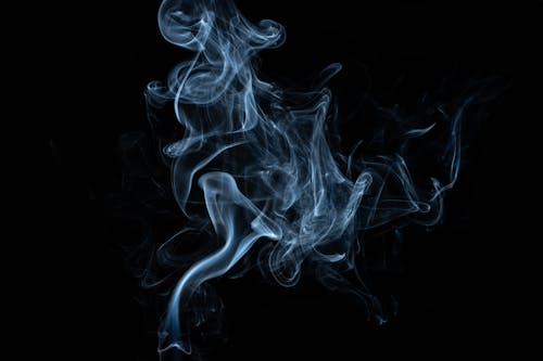 Free Abstract backdrop of moving steam with swirls and shiny surface on black background Stock Photo