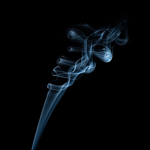 Free Abstract backdrop of shiny smokey creating fantastic waves in air in evening on dark background Stock Photo