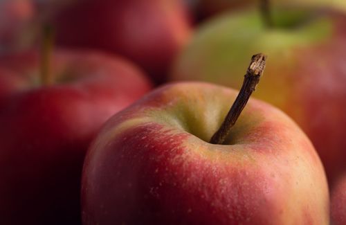 Free Vibrant close-up of fresh apples with stems showcasing natural texture and colors. Stock Photo