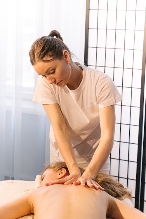 Masseuse Massaging a Person's Back
