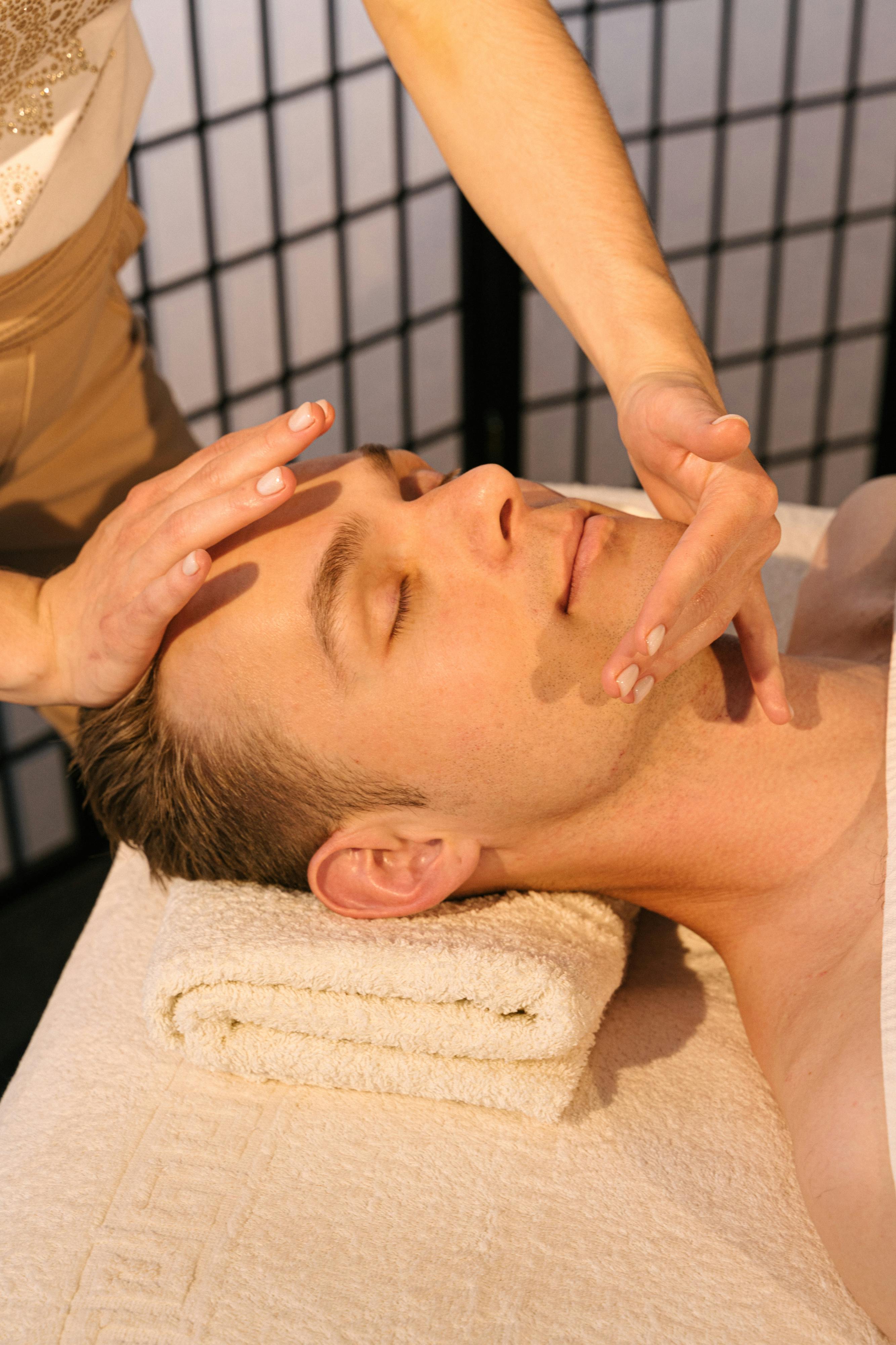 man having a face massage in a spa salon