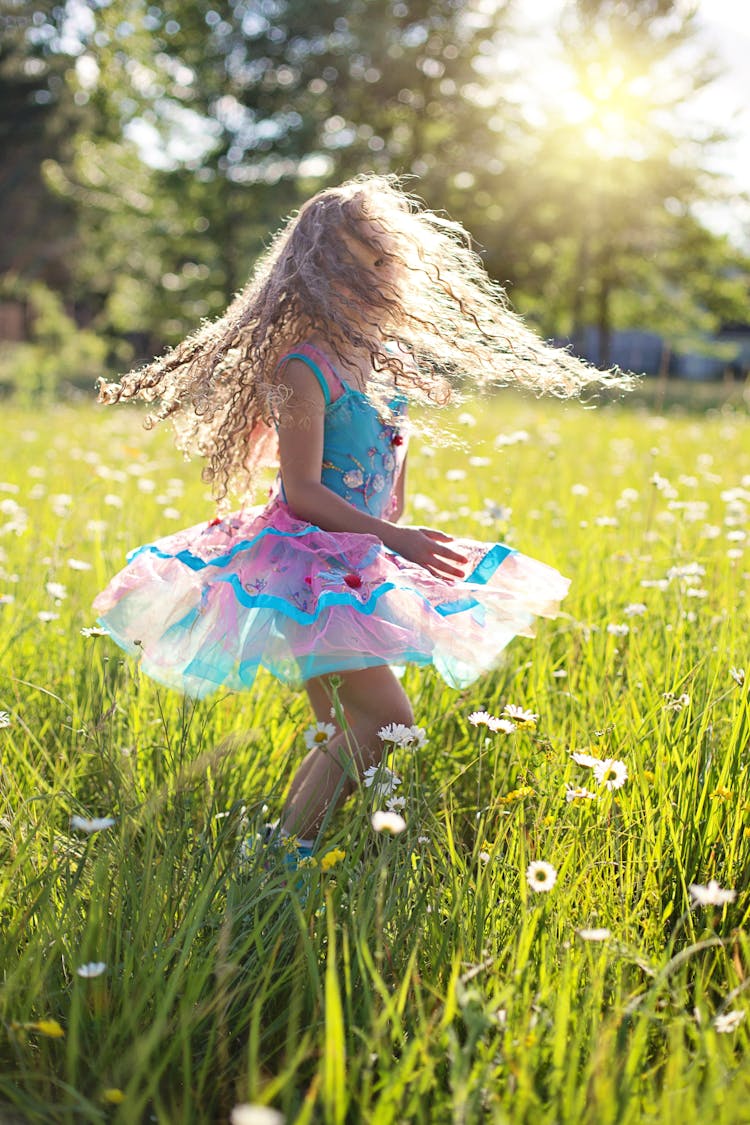 Brown Haired Kid On Grass Field