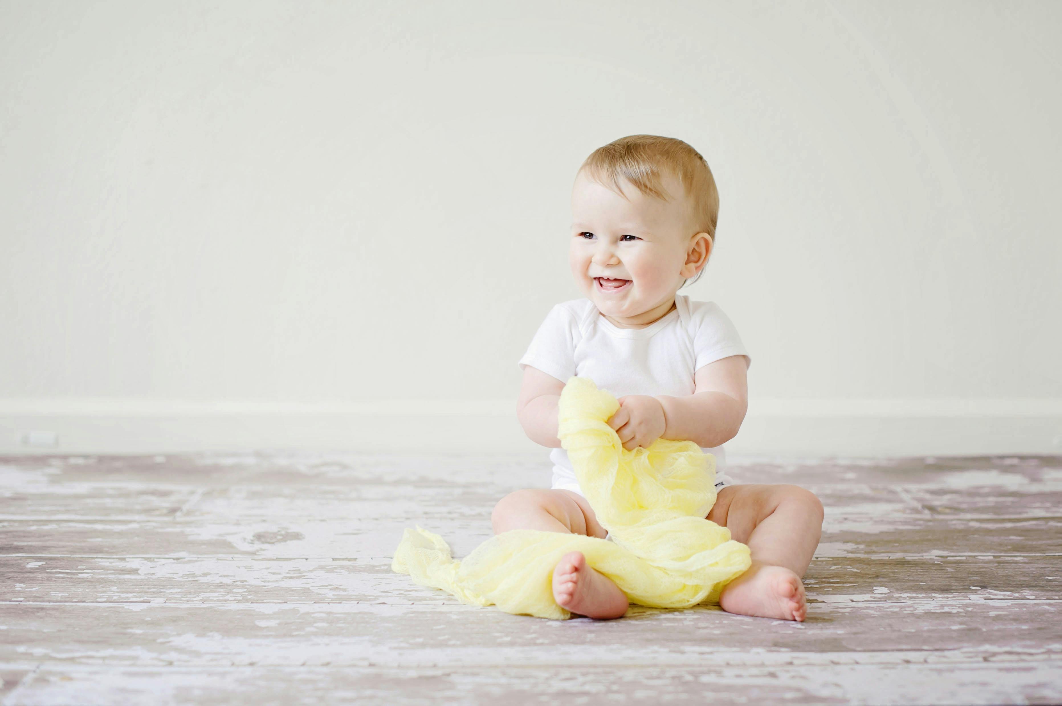 toddler sitting while smiling